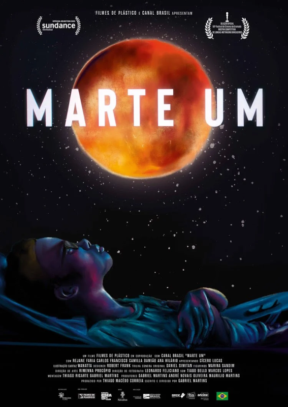 Imagem do poster do filme Marte Um, com um fundo do céu noturno estrelado e o planeta Marte no topo e o personagem Deivinho deitado olhando para cima